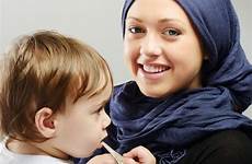 arabic mother muslim taking playing care baby her