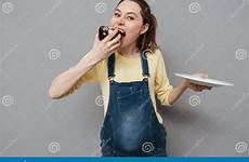 hungry pregnant eating chocolate portrait cake pretty woman isolated gray background women