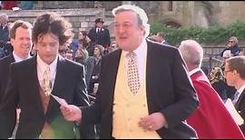 Stephen Fry arrives with husband Elliott Spencer for royal wedding