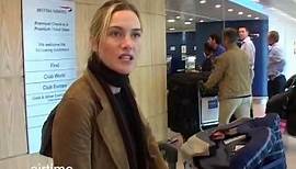 Kate Winslet pushes the luggage as Sam Mendes hold the baby