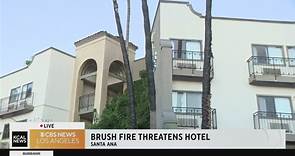 Brush fire threatens hotel in Santa Ana