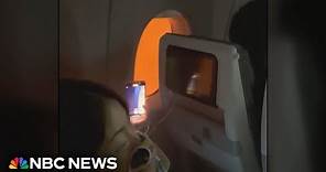 Video shows passengers stuck on burning plane in Japan
