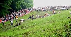 Watch people chase a cheese wheel down a hill in a bizarre English tradition
