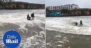 Heart-stopping moment girl on a beach is swept away by the tide - Daily Mail