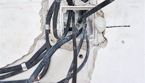 Socket for Wiring in a Concrete Wall. Renovation Concept Stock Photo