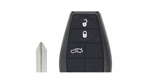 the remote control is next to an open door and a key fobl holder
