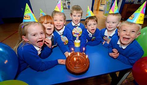 Children enjoy birthday cake and balloons at school lockdown party