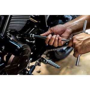 mechanic working on a motorcycle