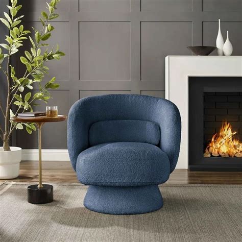 A Blue Chair Sitting In Front Of A Fire Place Next To A Potted Plant