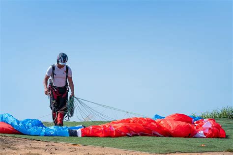 Photo Of Man Holding Parachute · Free Stock Photo