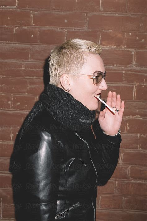 lesbian woman lighting cigarette by stocksy contributor alexey kuzma stocksy
