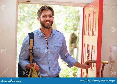 Young Man Returning Home For Work With Shopping Stock Photo Image Of
