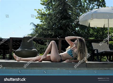 Blonde Women Lying Poolside Blue Bikini Stock Photo