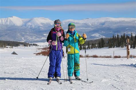 Two People On Skis Posing For The Camera