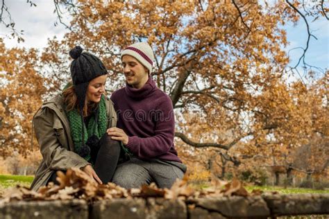 Young Couple Talking Sit In A Bench In The Park Stock Image Image Of