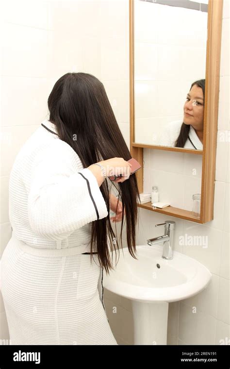 40 Year Old Latina Woman Cares For And Brushes Her Long Hair In The