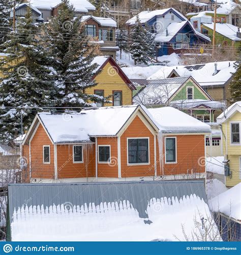 Square Colorful Home Cabins With Snowy Roofs In Snow Covered Park City
