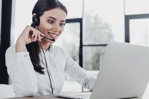 Beautiful Female Call Center Worker With Headphones And Laptop Sitting