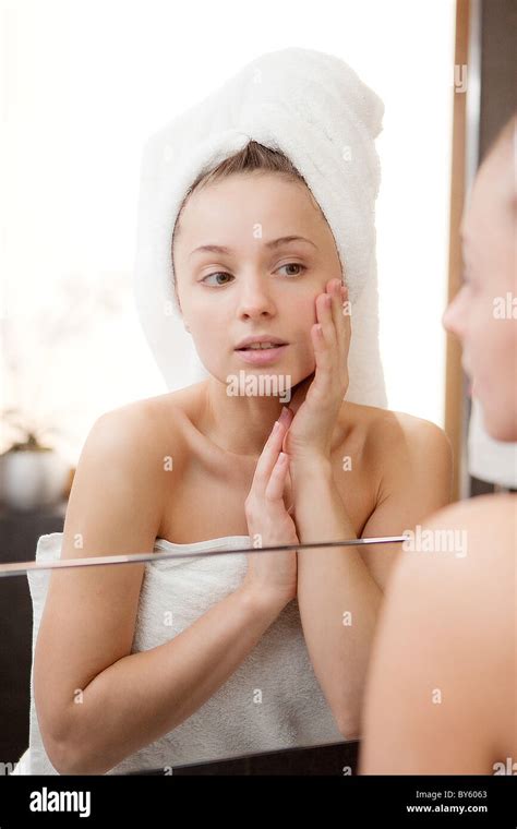 Woman Looks Into A Mirror Stock Photo Alamy