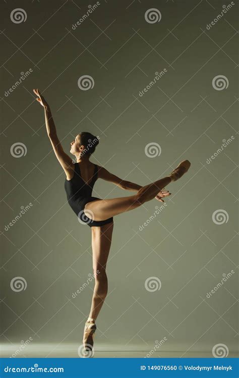 Young Graceful Female Ballet Dancer Dancing In Mixed Light Stock Photo