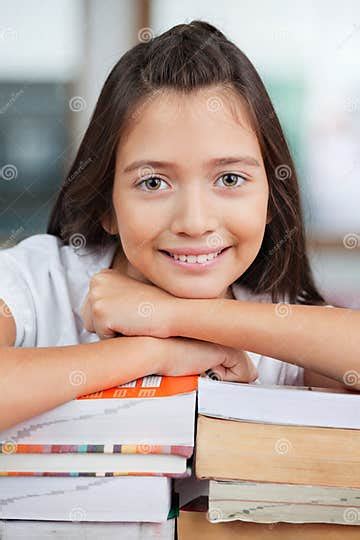 Schoolgirl Leaning On Stack Of Books In Classroom Stock Image Image Of Classroom Academic