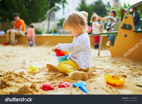 Adorable Little Girl On Playground Sandpit Stock Photo 1714033480