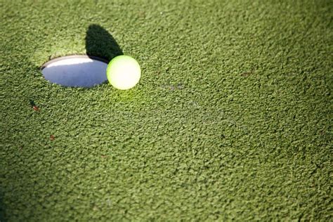 Golf Ball Putting On The Edge Of A Hole Stock Photo Image Of Green
