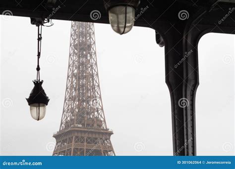 The Eiffel Tower Elevator From The Bir Hakeim Bridge In The Rain In