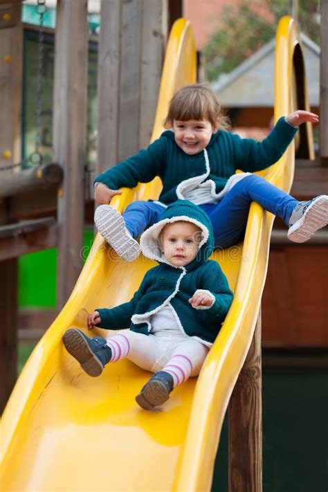 Two Happy Children On Slide At Playground Stock Image Image Of