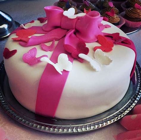 Round White Cake With Pink Bow And Butterflies On Top