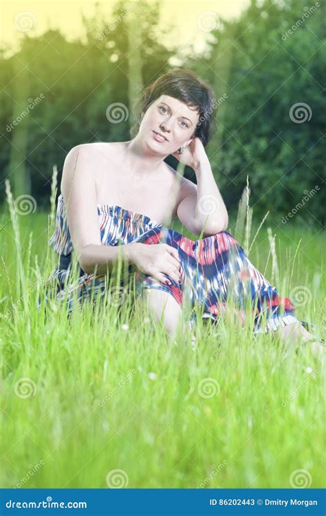 Caucasian Brunette Woman Posing Outdoors On Nature Background At Sunset