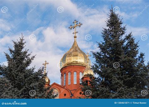 Old Red Brick Christian Church With Golden And Gilded Domes Against A