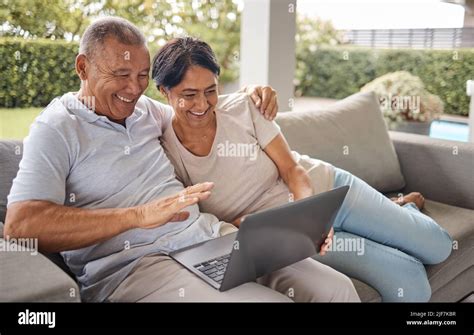 Senior Couple Making A Video Call On A Laptop At Home Two Happy People