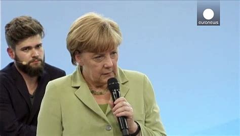Merkelstrokes The German Chancellor Is Confronted By A Crying Refugee Video Dailymotion