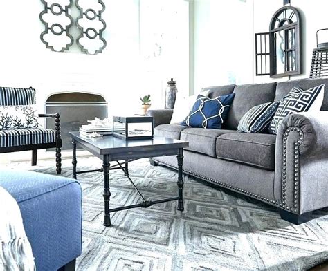 She has a tan and black geometric diamond rug under her dining table and a braided rug grounding the or, according to donna, you could vary the patterns of multiple rugs in a room as well. How To Mix And Match Sofa Cushions - Fella Design