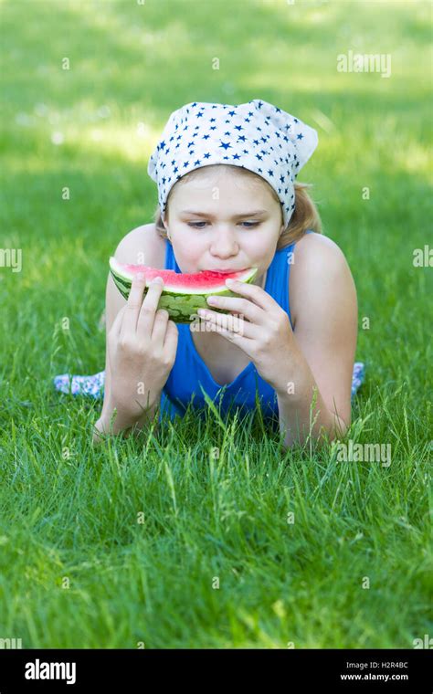 Cute Little Girl Eating Watermelon On The Grass Stock Photo Alamy