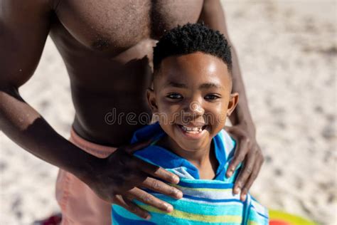 Portrait Of Smiling African American Boy Wrapped In Towel With