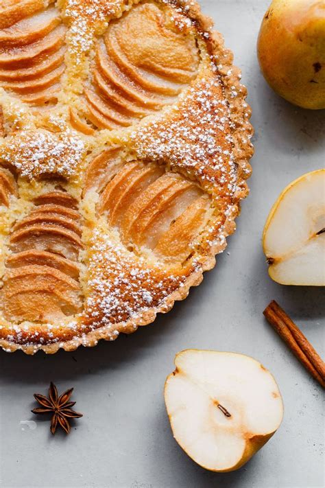this classic french poached pear tart is made with a sweet tart dough and filled with poached