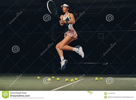 Female Tennis Player In A Jump On A Tennis Court Stock