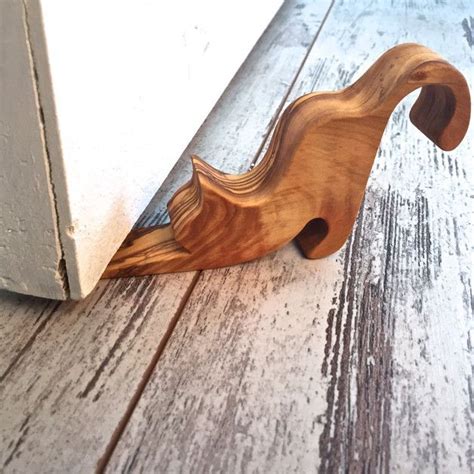 This Rustic Door Stopper With Cat Shape Is Made From Fallen Olive Tree