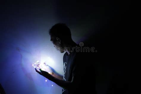 A Person Who Is Holding Light In A Dark Place Stock Photo Image Of