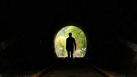 Man Walking To Light End Of Tunnel Search Of Hope Stock