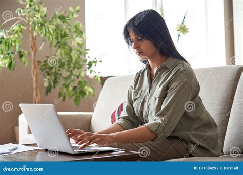 Young Indian Woman Using Laptop Computer Working At Home Office Stock
