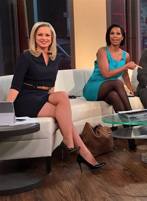 pretty blonde and black news casters both wearing sheer pantyhose with their legs crossed