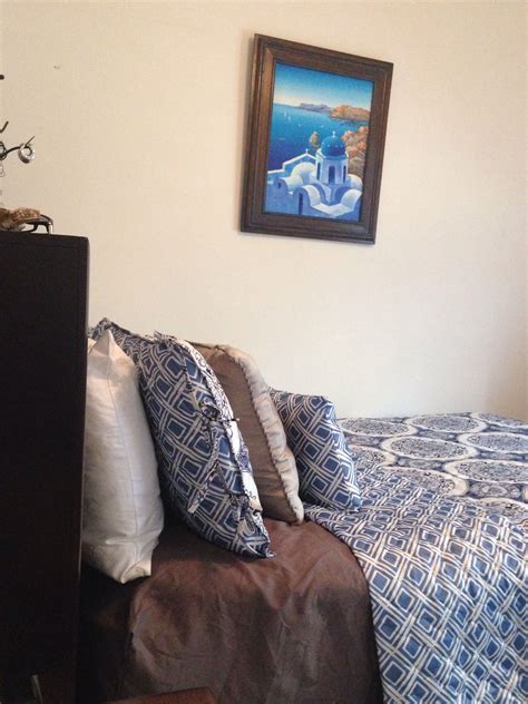 Bringing in a smooth and soft texture to the bed always feels sexy. Greek inspired bedroom. Painting from Santorini, Greece ...