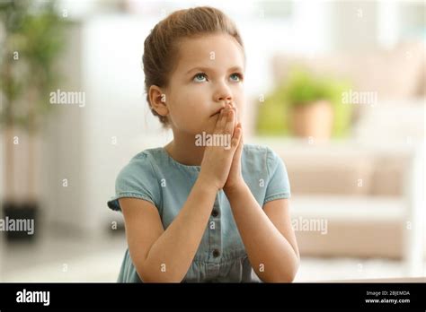 Cute Little Girl Praying At Home Stock Photo Alamy