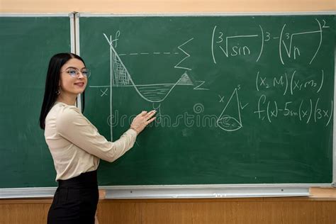 beautiful female teacher near blackboard learn mathematical in classroom stock image image of