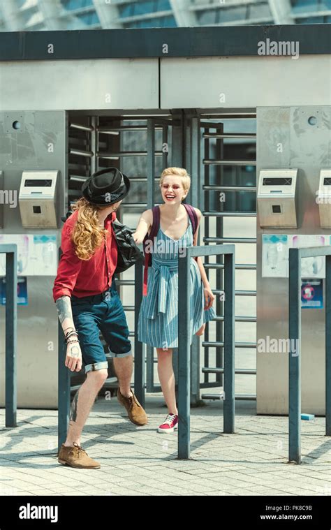 Cheerful Couple Of Tourists Holding Hands On Station Of Public