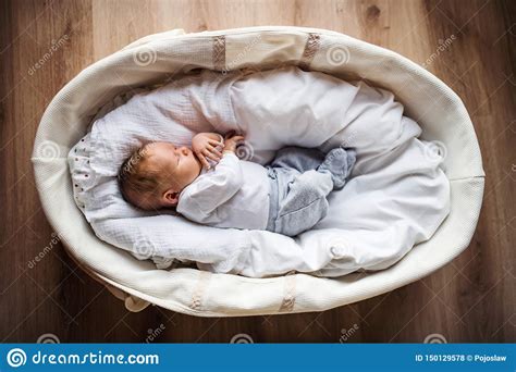 A Top View Of A Newborn Baby At Home Sleeping In A Moses Basket Stock