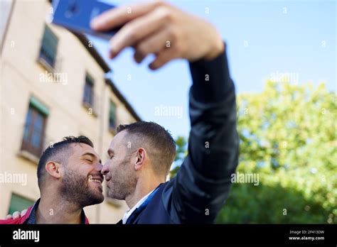 Gay Couple Making A Selfie With Their Smartphone Homosexual Relationship Concept Gay Couple